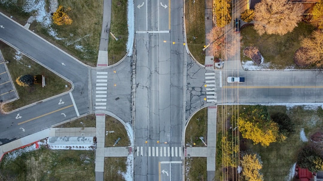 A top-down perspective of a four way intersection on a quiet road